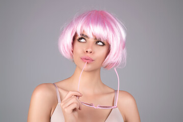 Funny girl with pink wig. Beauty skin. Woman beauty face, clean fresh skin natural makeup, beauty eyes and lips of female photo model.