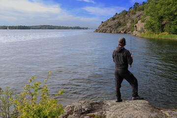 Fototapeta na wymiar One man fishing at a Swedish lake called Mälaren. September 2023.