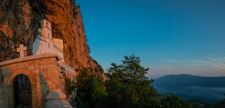 Evening view of Ostrog orthodox monastery in Montenegro or Crna gora, popular pilgrimage point in the balkans, viewed from frog perspective in sunny evening.