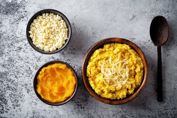 Millet porridge with pumpkin puree and cheese in a bowl