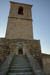 Fototapeta na wymiar Stone staircase to the bell tower of the church of Santa Maria in vertical Hervas