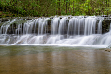 Late afternoon Summer photo of a waterfall in Robert H. Treman State Park near Ithaca NY, Tompkins County New York.	