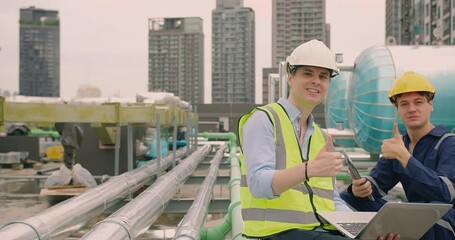 Portrait handsome Caucasian civil engineer Construction manager and worker inspector foreman in safety helmet looking at camera showing thumbs up and Smiling at construction site