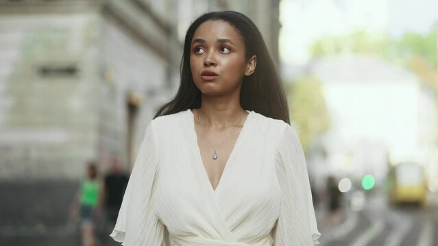 Worried female looking around and feels insecure at urban city Sad young woman suffering from depression anxiety loneliness or mental health problem outdoors Social phobia concept