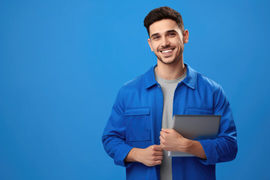 Man wearing blue jacket holding tablet. This image can be used to illustrate technology, communication, or business concepts.