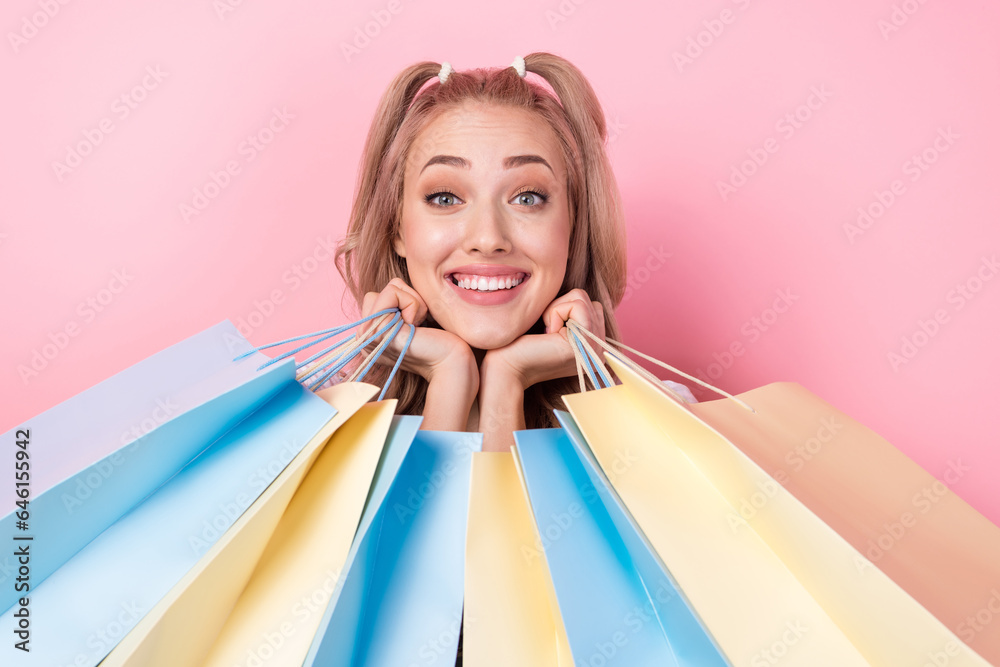 Poster photo of impressed woman with wavy hairdo dressed flower print clothes holding shopping bags under c