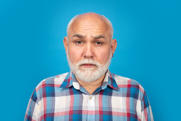 Fototapeta premium Closeup emotional portrait of an old mature senior man with grey beard isolated on studio background. Emotions sad faces.