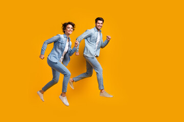 Photo of cheerful people jumping running for shopping discounts isolated bright color background