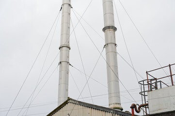 Flue chimney fixed to building exterior wall stainless steel from exhaust boiler plant room