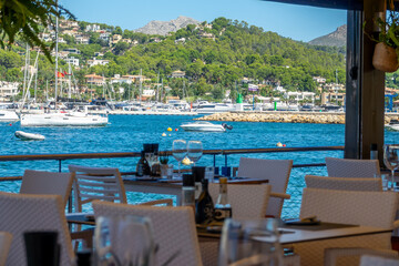 View of Port d'Andratx (Mallorca, Spain) through the tables of a restaurant by the sea
