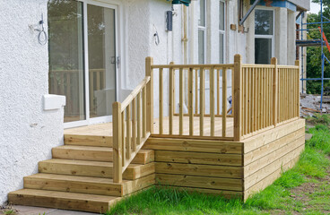 New decking built in garden at residential building refurbishment