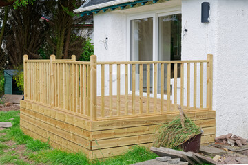 New decking built in garden at residential building refurbishment