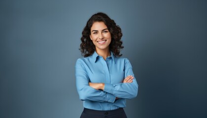 Happy young smiling confident professional business woman wearing blue shirt, pretty stylish female executive looking at camera, standing arms crossed isolated at gray background,  - obrazy, fototapety, plakaty