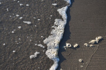 sea foam rolling in with the tide