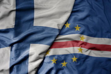 big waving national colorful flag of finland and national flag of cape verde .
