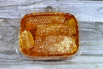 Hexagonal honeycomb cells with honey that hold the queen bee's eggs and store the pollen and honey...