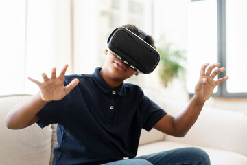 Professional african american gamer, teenager wearing VR glasses playing video game