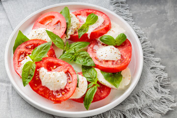 Caprese Salad Plated on White Plate with Stylish Gray Linen Napkin. Close up