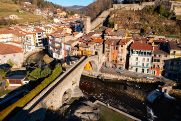 Drone view of the picturesque landscape of the small ancient Catalan town of Camprodon with the famous Roman bridge over ..the river Ter, Spain