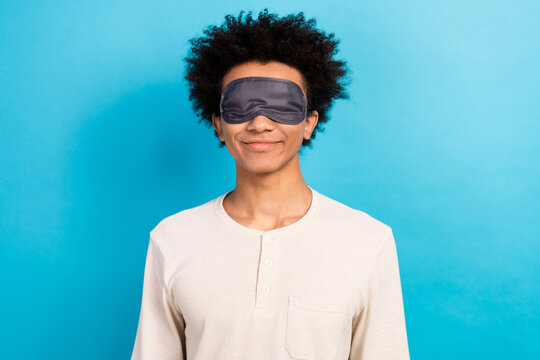 Photo Of Satisfied Funky Young Person Blindfold Mask Cover Eyes Sleep Recreation Isolated On Blue Color Background