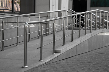 Ramp with metal handrails near building outdoors