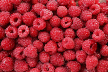 Heap of tasty ripe raspberries as background, top view