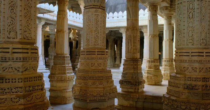 Columns of beautiful Ranakpur Jain temple or Chaturmukha Dharana Vihara. Marble ancient medieval carved sculpture carvings of sacred religious place of jainism worship. Ranakpur, Rajasthan. India