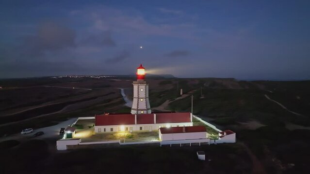 Aerial drone view of farol lighthouse on Cabo Espichel cape Espichel on Atlantic ocean in the evening. Sesimbra, Portugal, Europe
