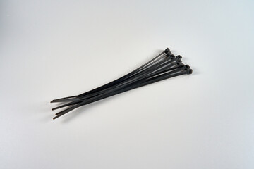Eight zip ties on a white background