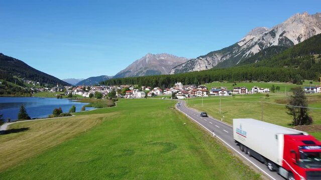 Aerial drone footage of the road along the Resia lake in the alps in northern Italy in Bolzano South Tyrol province just before the Austrian border on a sunny summer day 