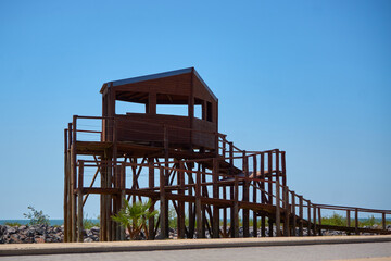 Birdwatcher's Wooden Oasis Beneath the Azure Sky