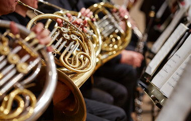 Close up of person hands playing horn	