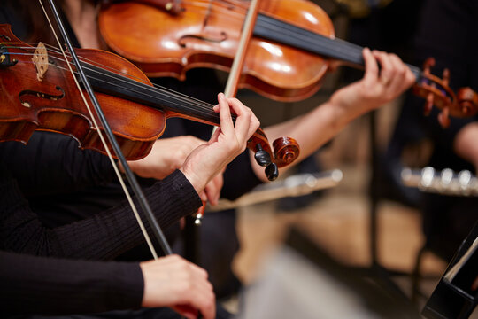 Naklejki Close up of musician hands playing violin