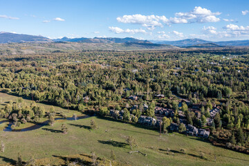 Aerial View of a Forested Subdivision in Wilson Wyoming next to a Ranch with Pasture Land