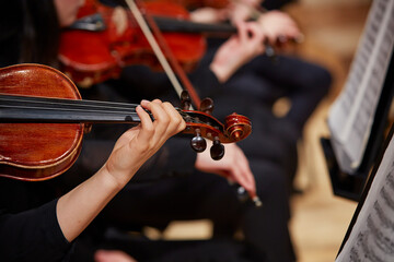 Close up of musician hands playing violin