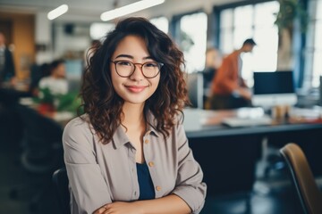 Fototapeta premium Smiling portrait of a happy japanese woman working for a modern startup company in a business office
