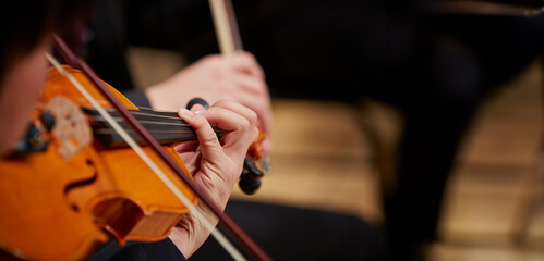 Close up of musician hands playing violin