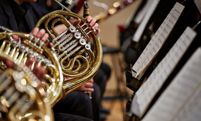 Close up of performer's hands playing horn