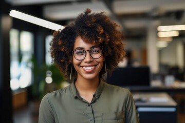 Smiling portrait of a happy young african american woman working for a modern startup company in a business ofice