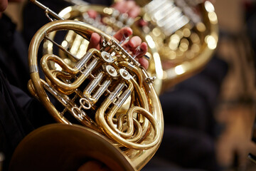 Close up of person  hands playing horn