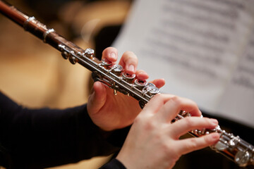 Close up of hands playing flute