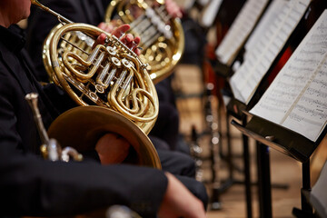 Close up of performer's hands playing horn