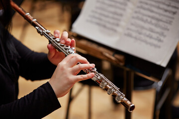 Close up of hands playing flute