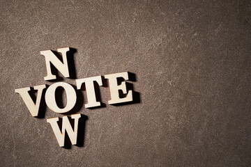 'vote' 'now' alphabet words on dark background