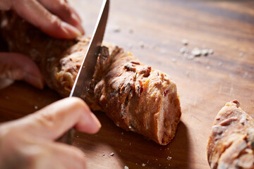 cutting bread with a knife on a cutting board