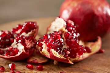Pomegranate seeds on cutting board