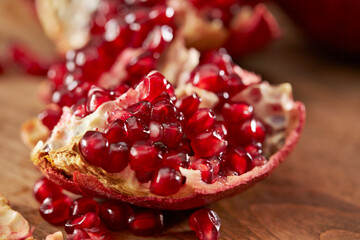 Pomegranate seeds on cutting board