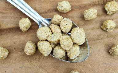 Soya mini chunks on a spoon close-up view 