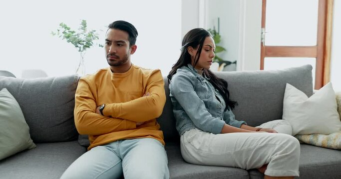 Conflict, fight and couple angry on a couch together duo to infertility, argument and toxic relationship in a home. Unhappy, divorce and man has problem with woman in a living room sofa for cheating