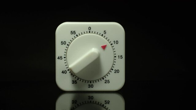 Time lapse of a kitchen clock timer countdown to zero.